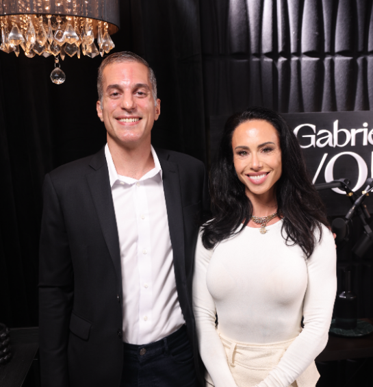 A man and woman in fancy attire smiling